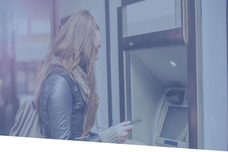Woman uses ATM machine 